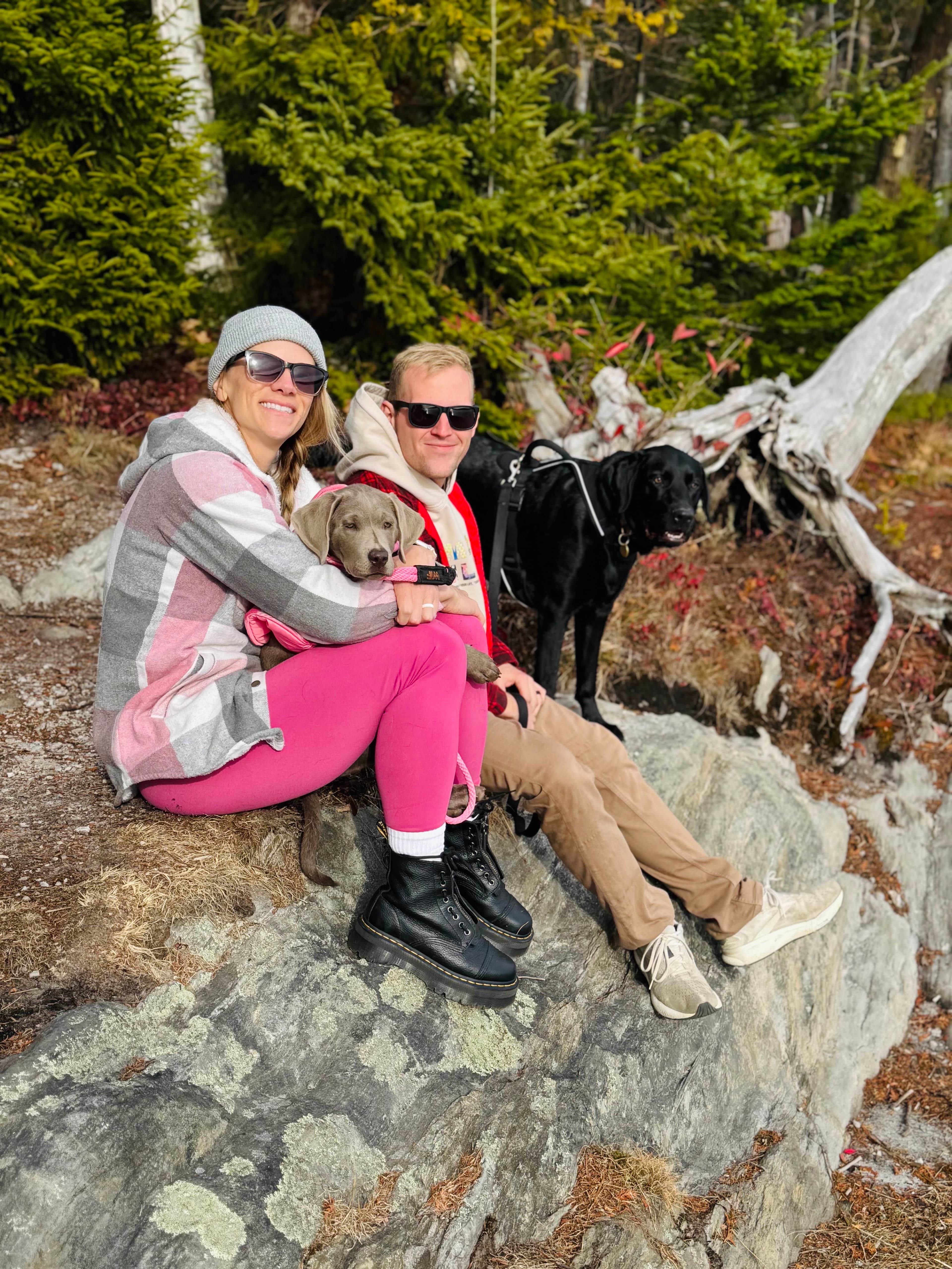 Rachel and Zach Boyd with their dogs on a hiking trail